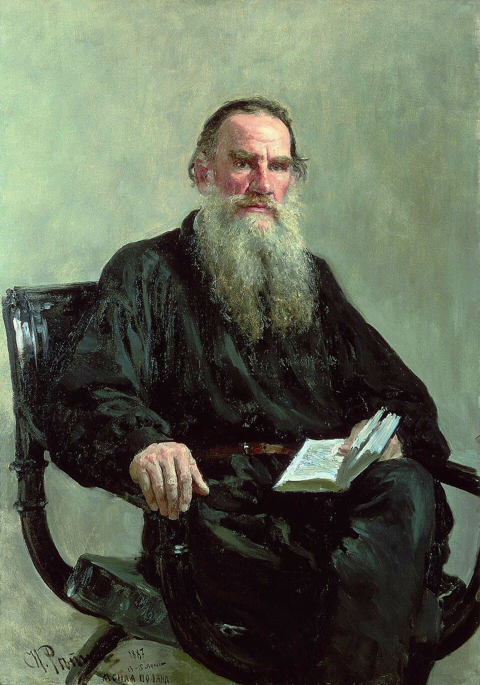 Ilya Repin’s portrait of Leo Tolstoy, seated with a long beard and dark shirt.